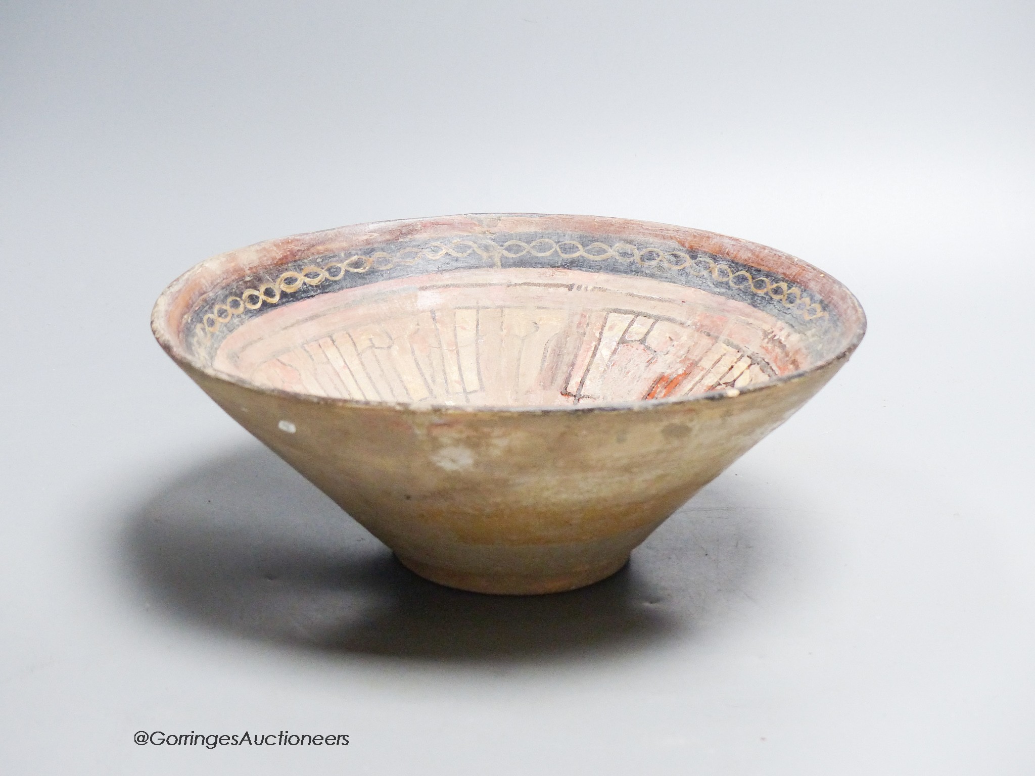 An Islamic bowl with kufic script, diameter 24cm
